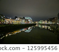 Midnight Cityscape Reflection with Tower Blocks and Clouds Over Lake 125995456