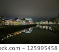 Urban Cityscape at Midnight by the Lake with Tower Block Reflections 125995458