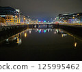 Cityscape at Dusk with Waterway and Bridge Reflections 125995462