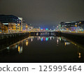 Cityscape at Dusk with Tower Blocks and Bridge Over Lake 125995464