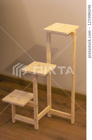 Close up shot of assembled wooden shelf for plants in pots 125996046