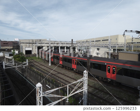 Toei Asakusa Line 12-600 series train entering the Tokyo Metropolitan Bureau of Transportation Magome Vehicle Inspection and Repair Shop 125996233