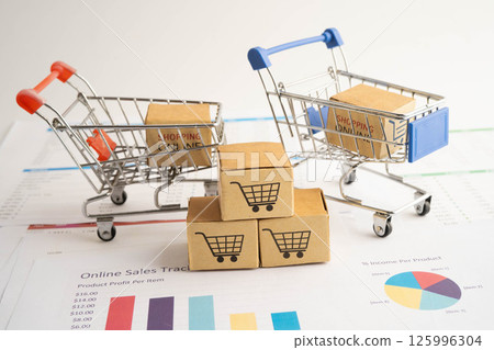 Online shopping, Shopping cart box on business graph, import export, finance commerce. Online shopping, Shopping cart box on business graph, import export, finance commerce. 125996304
