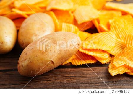 Potato chips , delicious BBQ seasoning spicy for crips, thin slice deep fried snack fast food. Potato chips , delicious BBQ seasoning spicy for crips, thin slice deep fried snack fast food. 125996392