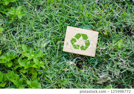 Top view of Recycle symbol on wooden block with customizable space for text. For a greener tomorrow concept Top view of Recycle symbol on wooden block with customizable space for text. For a greener tomorrow concept 125996772
