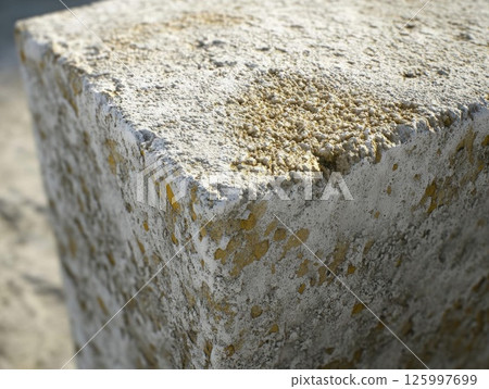 Close-up of Weathered Concrete Block: A Textured, Grainy Surface 125997699
