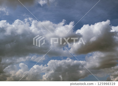 Beautiful bright sky with fluffy clouds. Natural clouds with blue sky background 125998319
