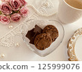 Pink roses, cookies and chocolates 125999076