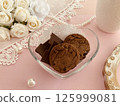 Pink roses, cookies and chocolates 125999081