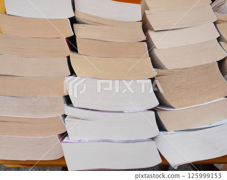 A stack of books with the top one being the thinnest A stack of books with the top one being the thinnest 125999153
