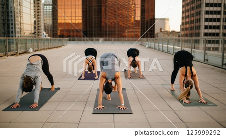 Rooftop Yoga at Sunset Over Skyline, Urban Wellness Escape 125999292