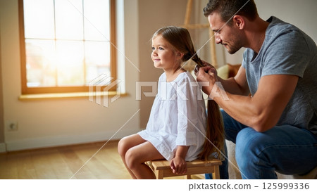 Father Braiding Daughters Hair in Morning Light, Tender Parenting Moment Father Braiding Daughters Hair in Morning Light, Tender Parenting Moment 125999336