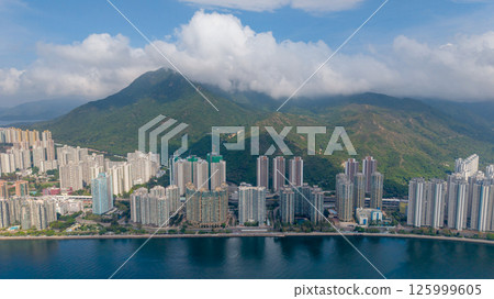 Waterfront Cityscape with High Rise Buildings and a Mountainous Backdrop May 4 2025 125999605