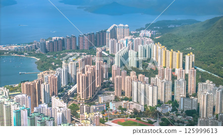 Vibrant Cityscape with High-Rise Buildings by the Sea Vibrant Cityscape with High-Rise Buildings by the Sea 125999613