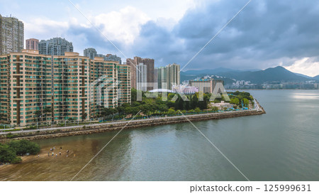 Coastal View of Island with Urban and Mountain Backdrops May 4 2025 125999631
