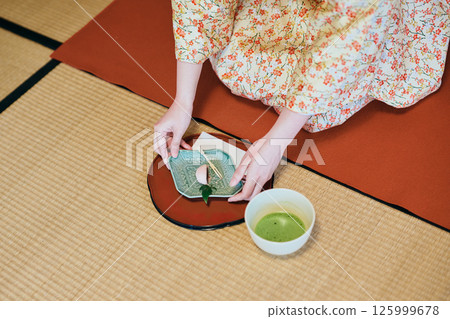 A woman in her twenties wearing a kimono experiencing a tea ceremony A woman in her twenties wearing a kimono experiencing a tea ceremony 125999678