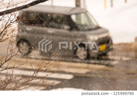 Snowy road and car 125999780