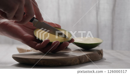 man cut green mango on olive wood board man cut green mango on olive wood board 126000317