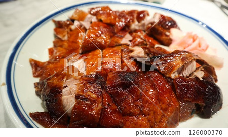 close up of Cantonese roasted goose cut into pieces with ginger slices on the side close up of Cantonese roasted goose cut into pieces with ginger slices on the side 126000370