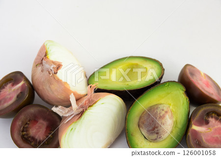 Vegetables black tomatoes, avocado and onions on white background 126001058