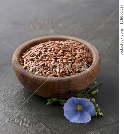 Flax seed and flax flower on concrete backgrounds 126001152