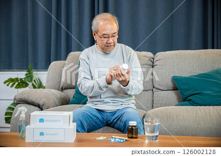 Asian worried senior man with medicine pills to taking on table in the living room, old man buy herbal self cure Rx pill online from pharmacy, home isolation, health care help service Asian worried senior man with medicine pills to taking on table in the living room, old man buy herbal self cure Rx pill online from pharmacy, home isolation, health care help service 126002128