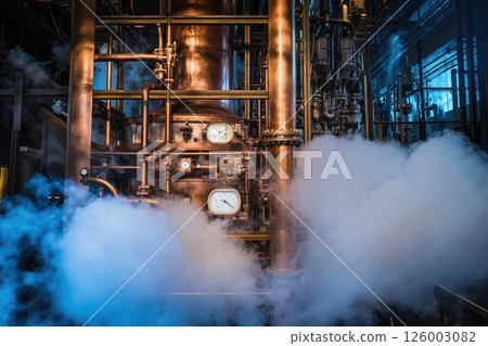 Industrial steam machines in atmospheric factory setting with vintage copper pipes and dials Industrial steam machines in atmospheric factory setting with vintage copper pipes and dials 126003082