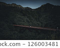 A red bridge in the quiet mountains and a traveling car A red bridge in the quiet mountains and a traveling car 126003481