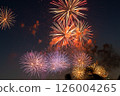 A summer night sky filled with red and gold fireworks A summer night sky filled with red and gold fireworks 126004265
