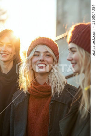 Cozy winter fashion gathering at sunset with friends 126004384