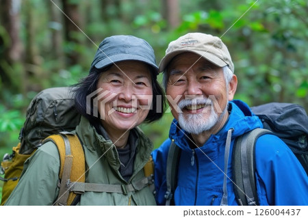 Joyful senior couple embracing nature on a forest adventure Joyful senior couple embracing nature on a forest adventure 126004437