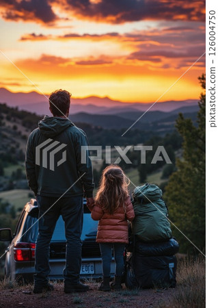 Father and daughter watching sunset over mountain landscape on adventure journey Father and daughter watching sunset over mountain landscape on adventure journey 126004750