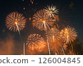 Golden fireworks and light trails in the night sky Golden fireworks and light trails in the night sky 126004845