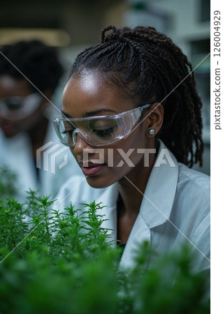 Innovative women in scientific research analyzing herbal plants in modern laboratory for sustainable medicine development Innovative women in scientific research analyzing herbal plants in modern laboratory for sustainable medicine development 126004929