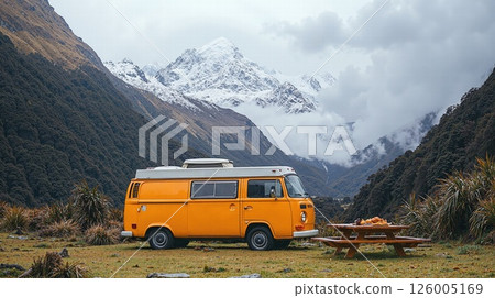 Adventurous road trip: vintage camper van amidst majestic snow-capped mountains for nature travel 126005169