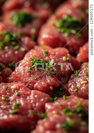 Close-up of fresh seasoned beef tartare with herbs for gourmet culinary presentation Close-up of fresh seasoned beef tartare with herbs for gourmet culinary presentation 126005175