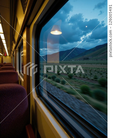 Scenic train journey at dusk through serene countryside landscapes under cloudy skies Scenic train journey at dusk through serene countryside landscapes under cloudy skies 126005491
