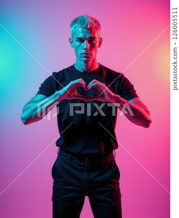 Vibrant neon portrait of man forming heart symbol in futuristic lighting for modern design projects 126005511