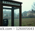 Vintage telephone booth in misty urban park reflecting nostalgia and seasonal atmosphere 126005643