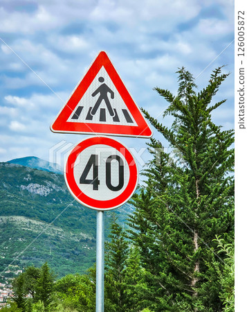 Road sign on the road: speed limit and pedestrian crossings 126005872
