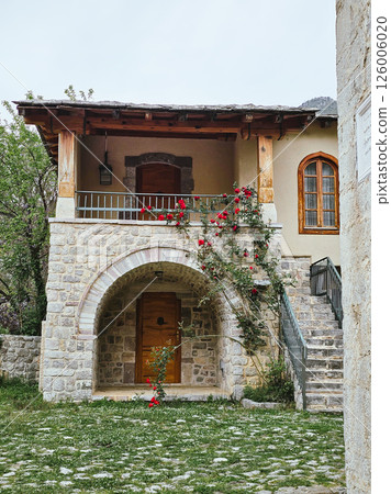 Stone House Surrounded by Blooming Flowers in a Picturesque Garden 126006020
