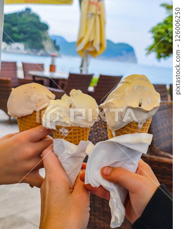 Ice Cream Cone in Hand on a Sunny Day Ice Cream Cone in Hand on a Sunny Day 126006250