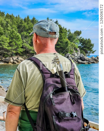 Man Looking at the Sea with a Fishing Rod and Backpack, Ready for Fishing 126006572