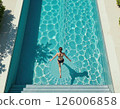 Tranquil poolside oasis with geometric water patterns for modern summer design and relaxation inspiration 126006858