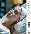 Tranquil spa serenity: relaxed woman resting in luxurious wellness retreat ambiance 126006859