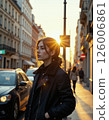 Urban autumn glow: contemplative stroll through golden city streets at sunset 126006861