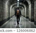 Urban exploration adventure: man in backpack walking through mysterious underground tunnel 126006862