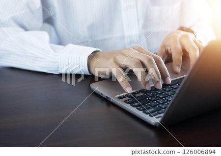 Businessman using a computer or laptop to work and communicate. 126006894