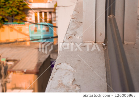 Weathered balcony ledge with peeling paint and urban background Weathered balcony ledge with peeling paint and urban background 126006963