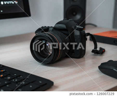 SLR camera on a desk 126007229